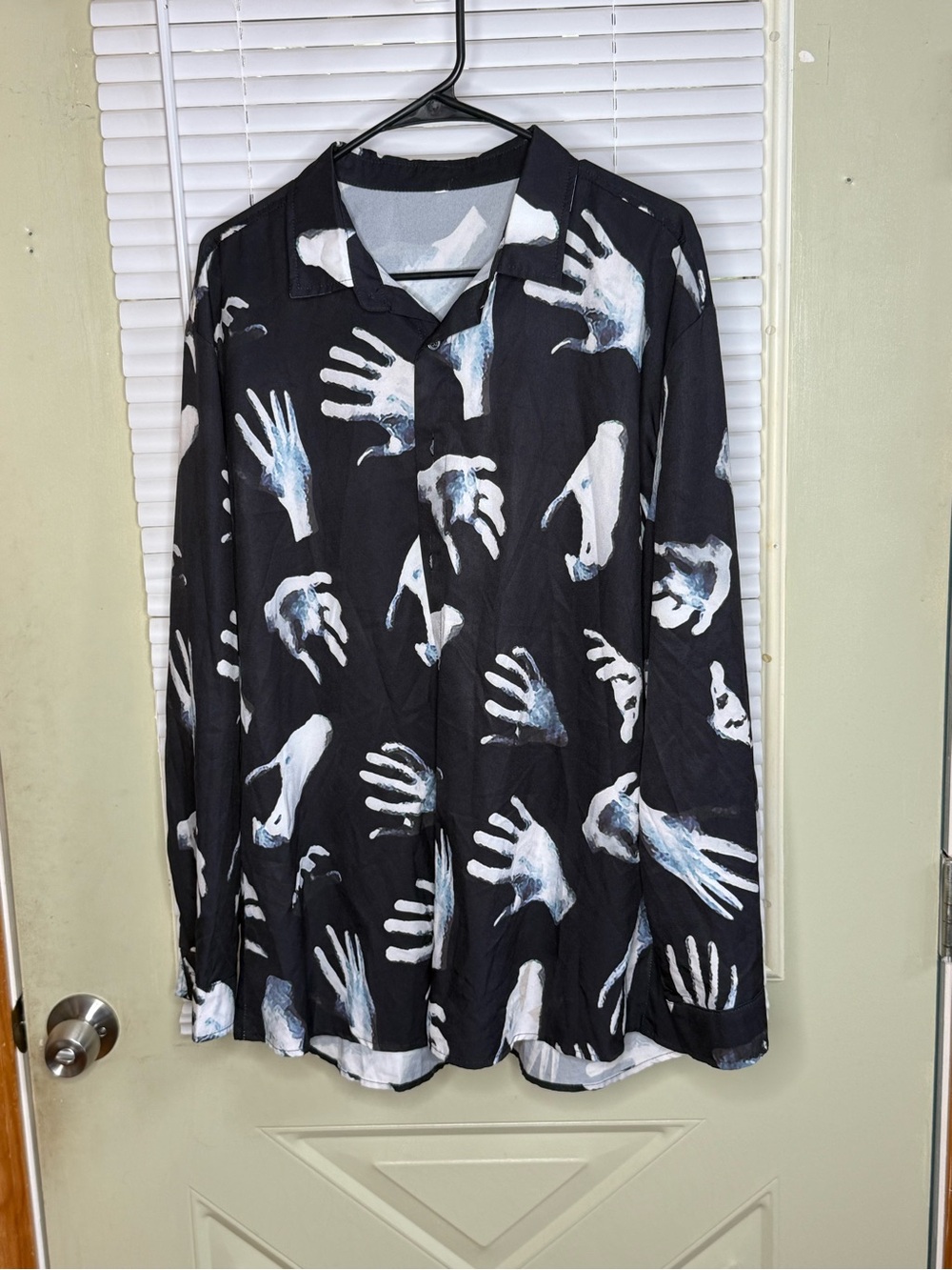 Black long-sleeve button-down shirt w allover white reaching hands graphic print
